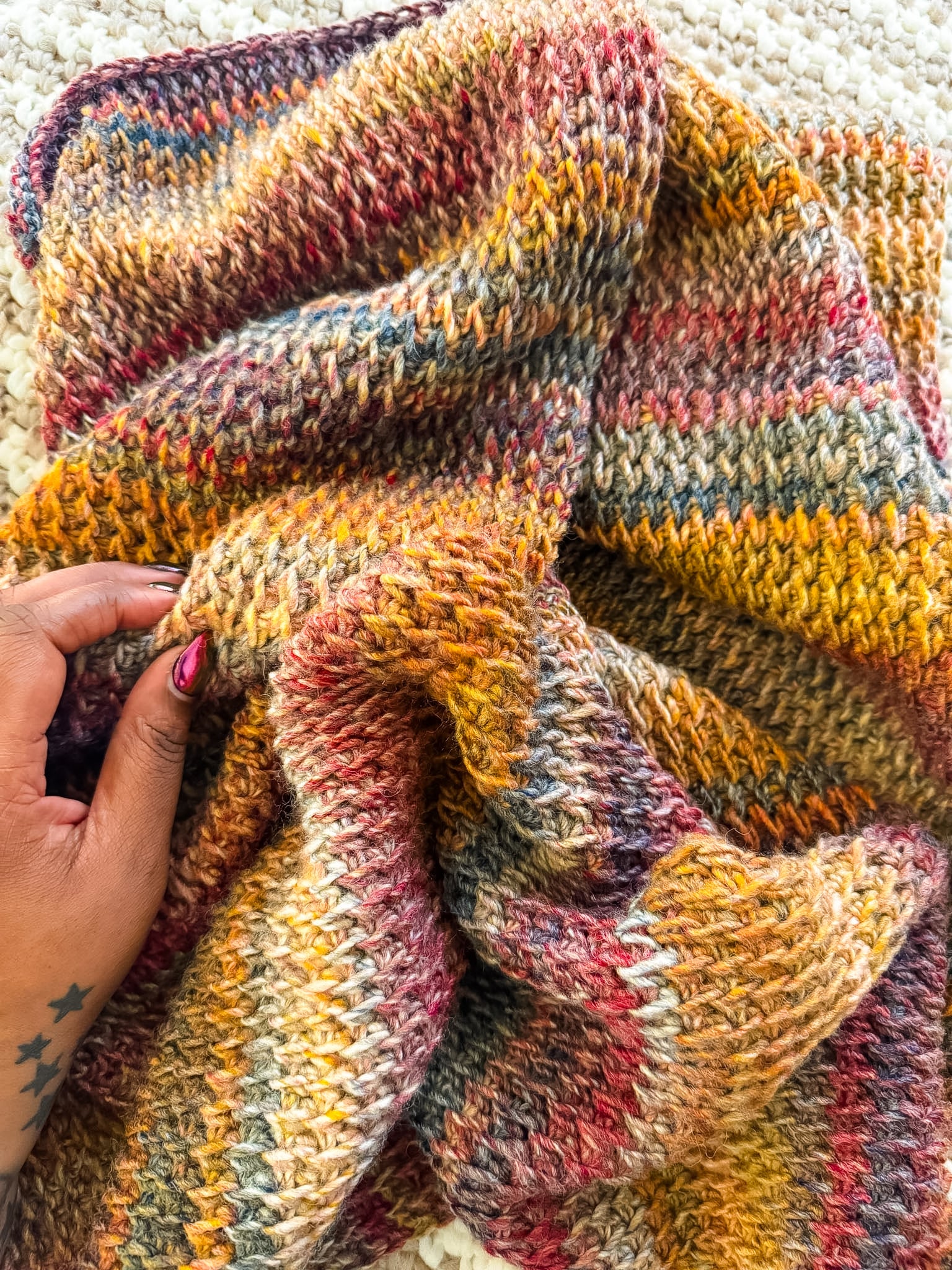 Toni Lipsey of TL Yarn Crafts working on a colorful Tunisian crochet project, showcasing the beautiful textures and creative possibilities of Tunisian crochet.