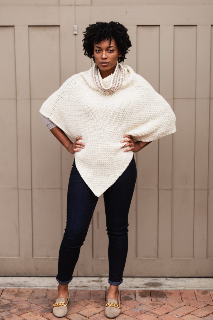 Learn to make this figure-flattering Tunisian Crochet Poncho for FREE! The Hot Cocoa Poncho is a Free Tunisian crochet pattern made simple from 2 rectangles. Pattern uses the honeycomb stitch and simple striping on the cowl neck. Pattern includes links to helpful tutorial videos and illustrations to make assembly a breeze. Project sponsored by JOANN. | TLYCBlog.com