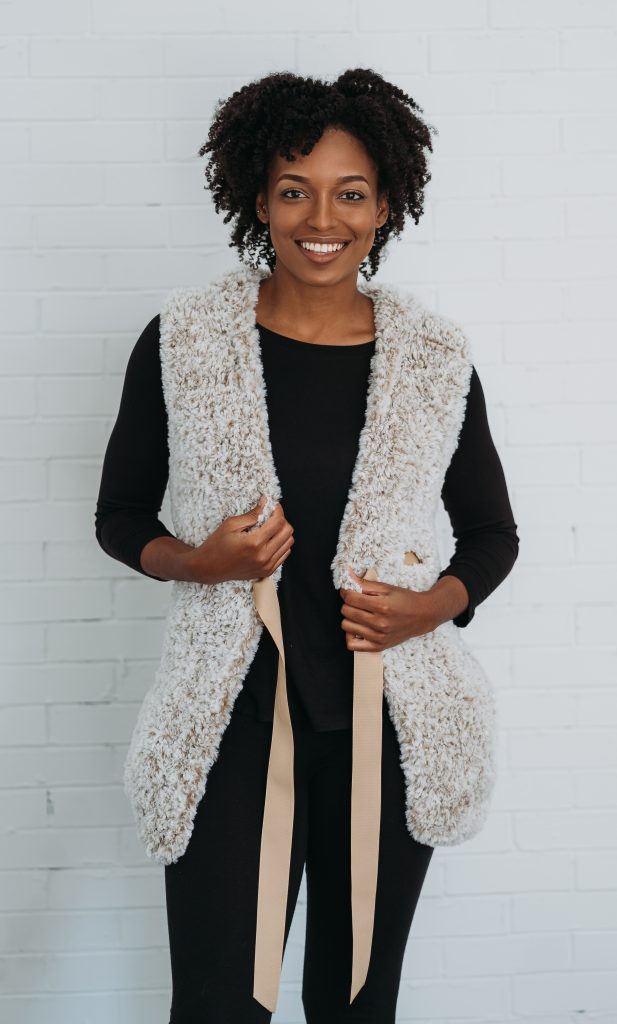 Mika Vest Crochet Pattern | Crochet Faux Fur Vest Pattern, sleeveless, with pockets and hood. Made with Super Bulky yarn in white color Fable Fur from Knit Picks, also available in Black, brown, gray, and tan. Wear with turtle necks or thin sweaters. Great holiday and winter outfit Inso. DIY your own faux fur vest! | TLYCBlog.com