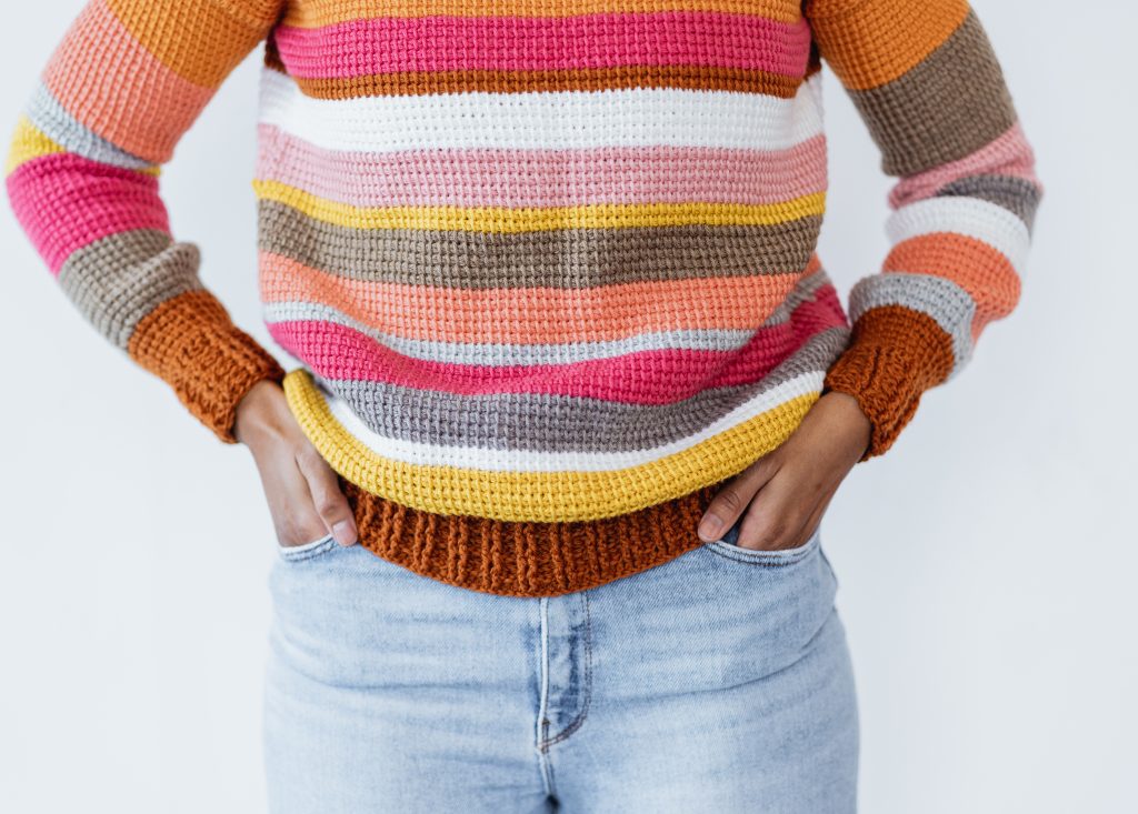 The Sedona Sweater - Free Tunisian crochet sweater pattern, beginner-friendly made with yarn from stash, leftover yarn, or any color yarn. Customize crochet sweater pattern, color block with stripes, ribbed cuffs and collar. TLYCBlog.com