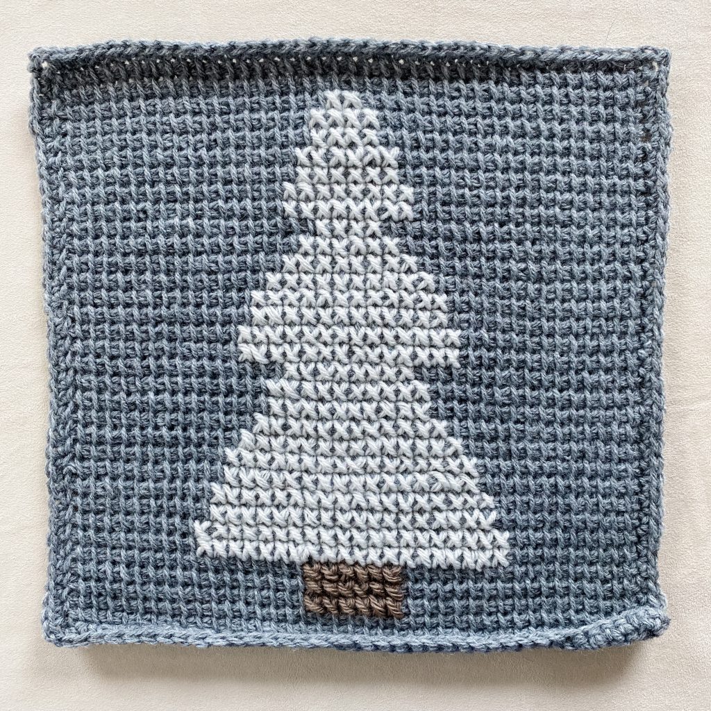 Learn how to cross stitch on Tunisian crochet. It’s easy and fun. Watch this cross stitch on Tunisian crochet tutorial video. Step by step pattern on how to cross stitch on Tunisian crochet. | TLYCBlog.com