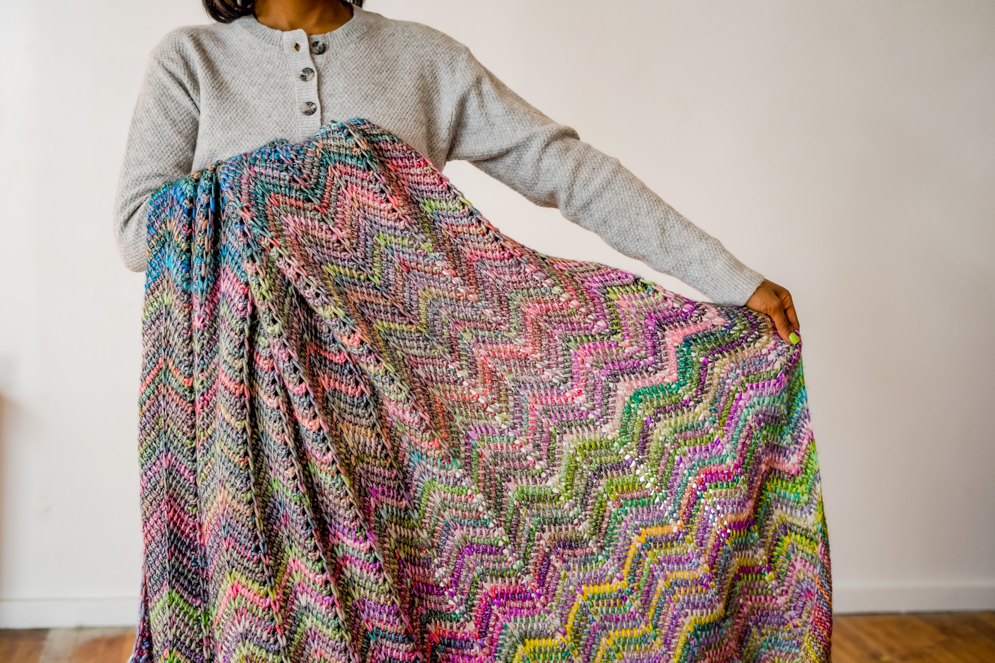 Beginner friendly Tunisian crochet chevron blanket with photo tutorial easy crochet throw blanket pattern worsted weight yarn.  | TLYCBlog.com