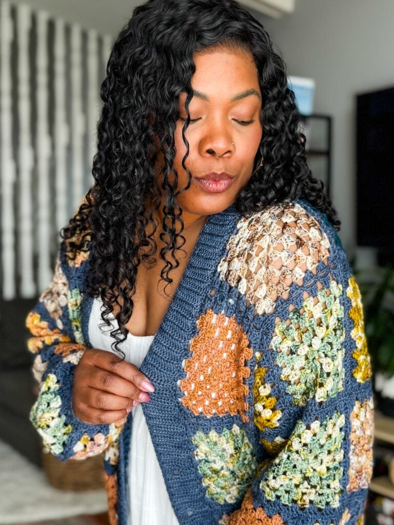 Handmade granny square Rose Cardigan modeled in warm multicolored yarns.