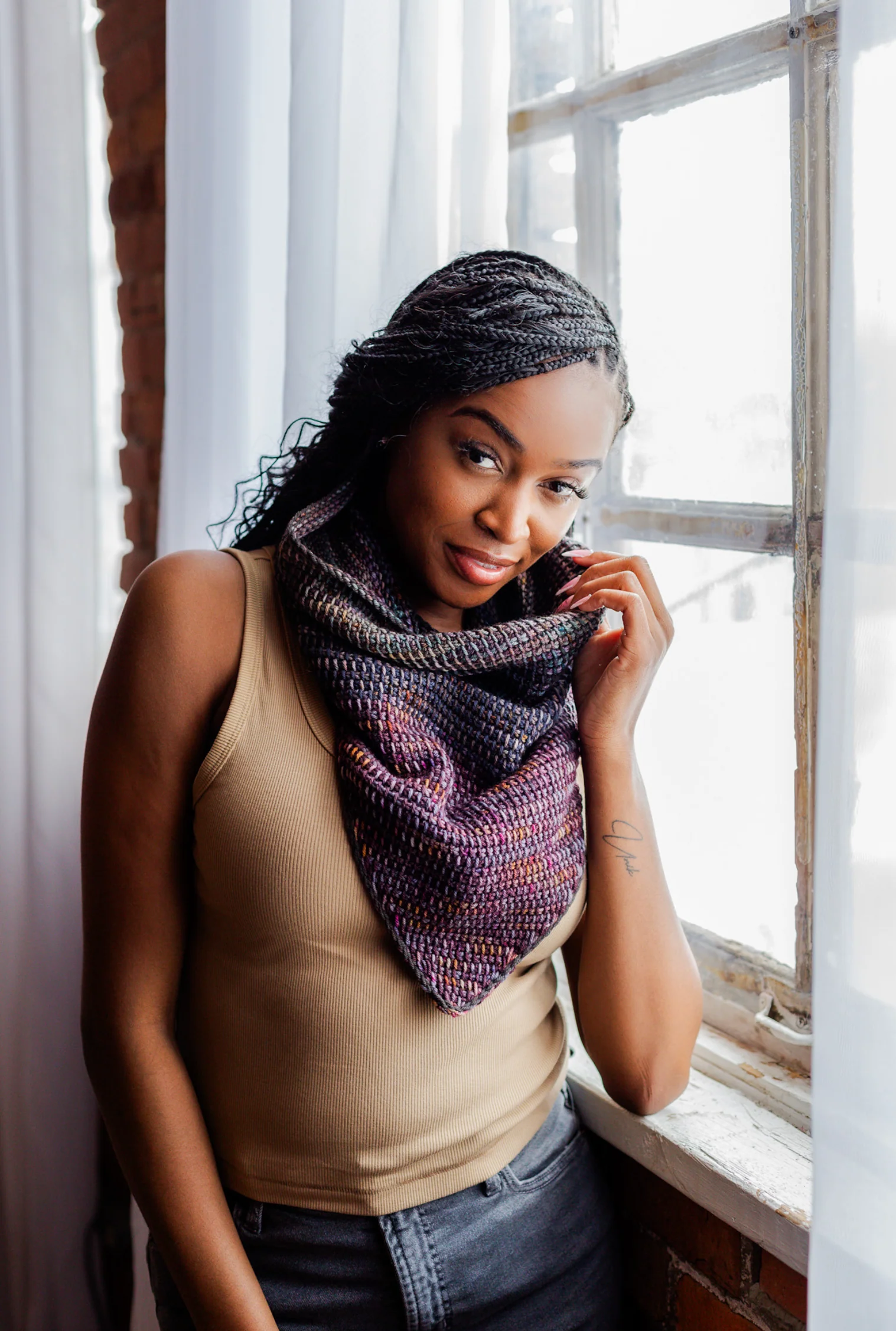 Model wearing the Nightfall Cowl crochet pattern made with DK weight yarn, featuring layered texture and stash-friendly color changes.