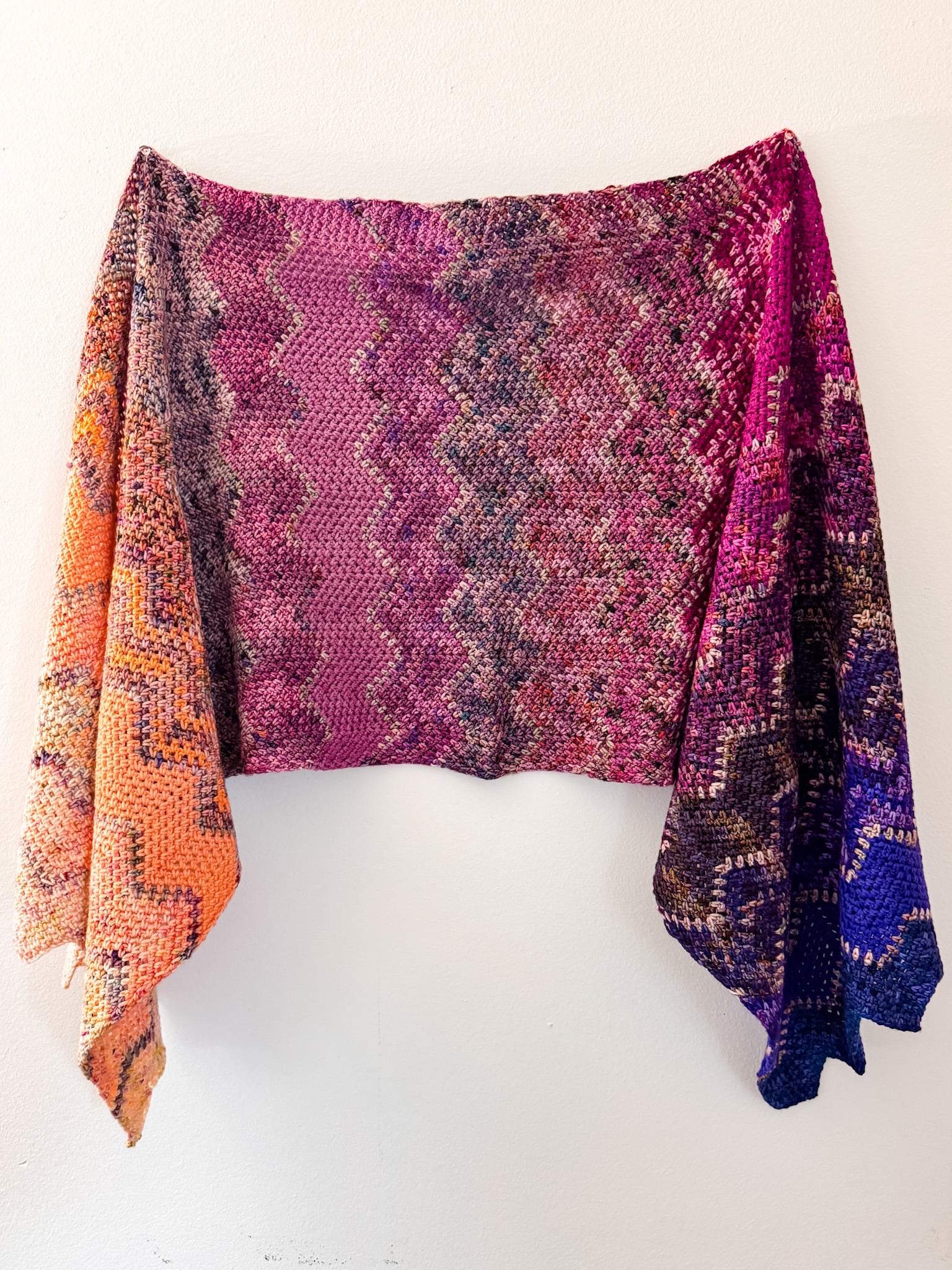 Finished Astral Advent Wrap crochet wrap with a soft drape and chevron texture in a multicolor advent yarn fade