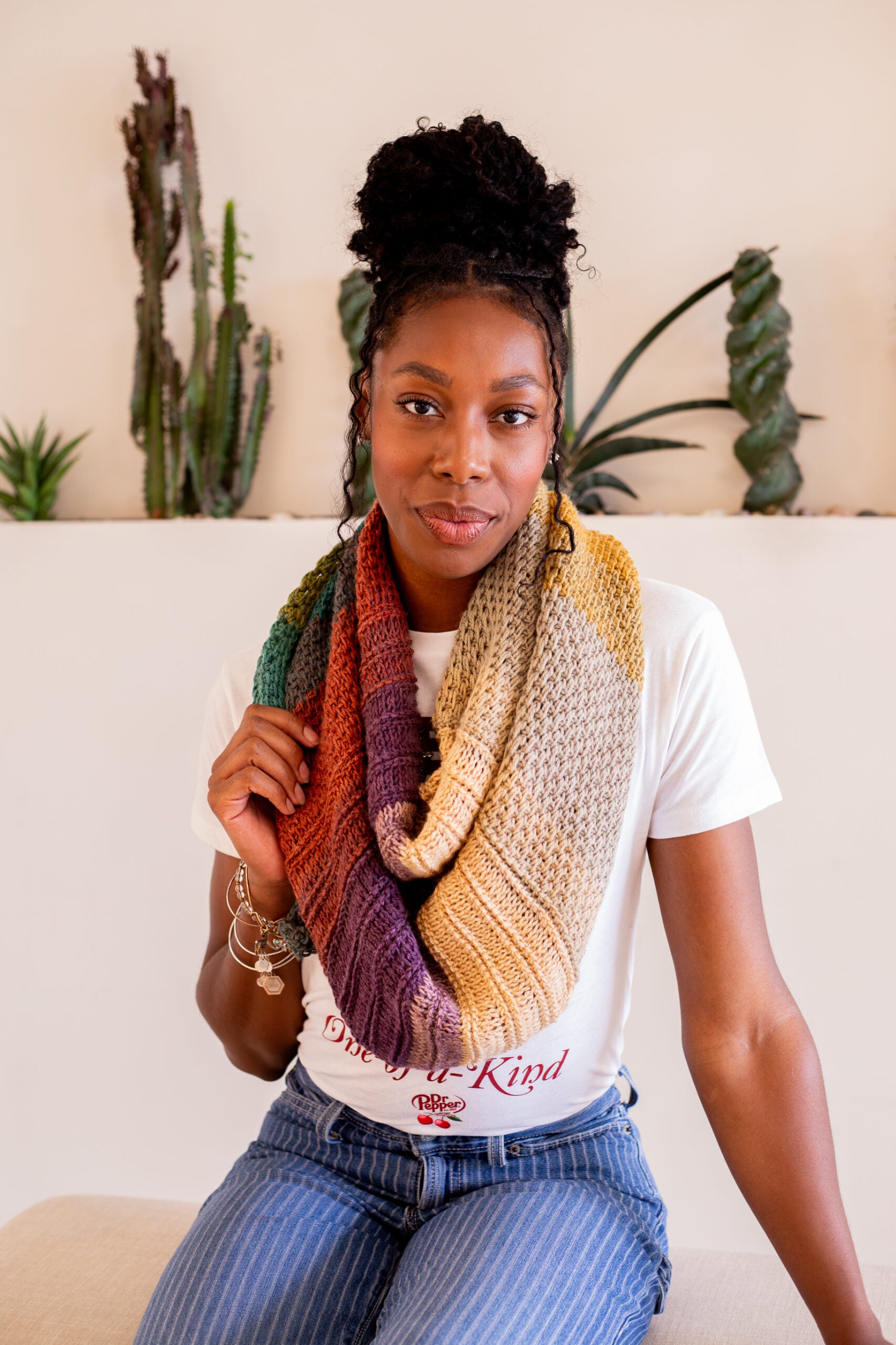 Highly textured Tunisian crochet wrap shawl styled with a graphic tee shirt and pinstriped jeans