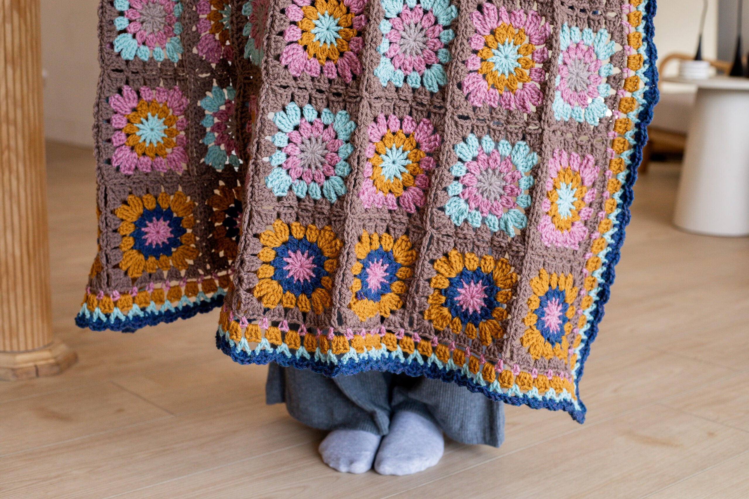 Multicolored granny square blanket with coordinating border