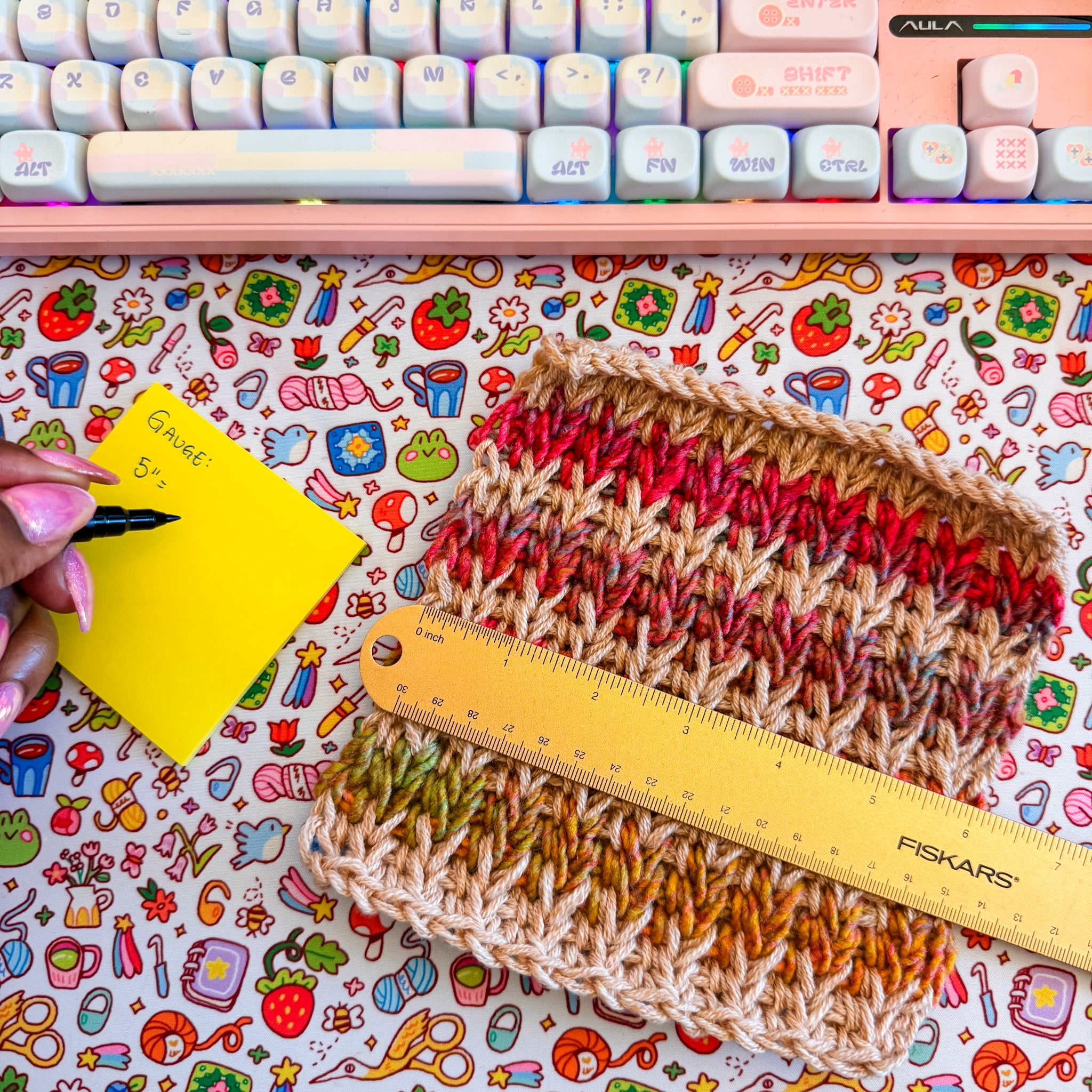 Crochet swatch being measured with a ruler while the five-inch gauge measurement is recorded on a note.